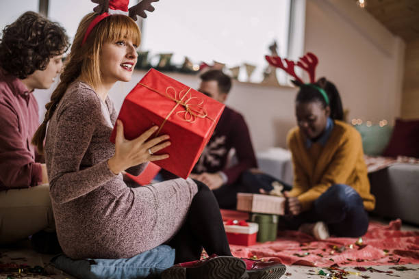 istock Friends Opening Christmas Presents 1074669746