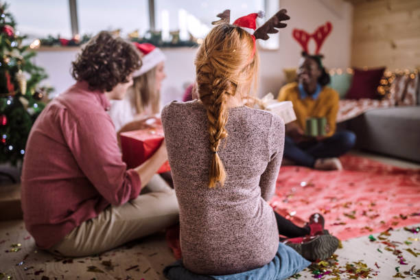 istock Friends Opening Christmas Presents 1074669824