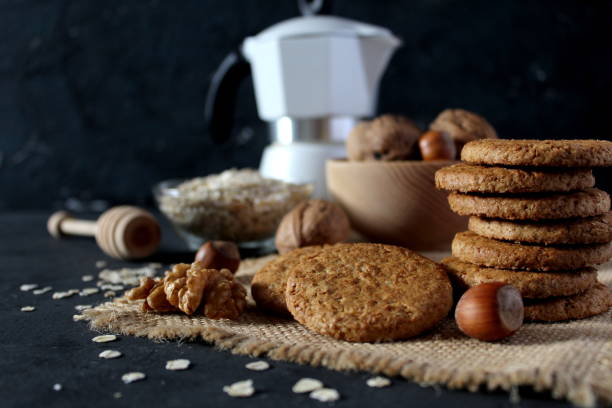 istock Sweet biscuit barley, oats and walnuts on the dark background. 1074671148