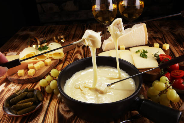 istock Gourmet Swiss fondue dinner on a winter evening with assorted cheese 1074671520