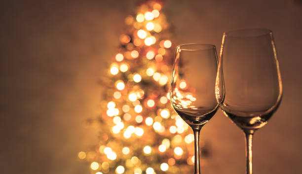 istock Two wine glasses next to christmas tree. 1074671586