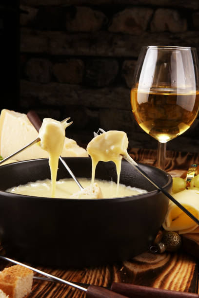 istock Gourmet Swiss fondue dinner on a winter evening with assorted cheese 1074674768
