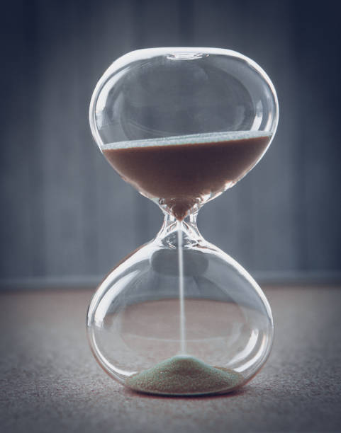 istock Hourglass measuring the passing time in a countdown to a deadline, on a blur background with copy space 1074682930