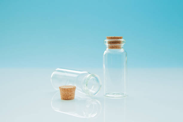 istock Empty little bottles with cork stopper on light blue background, close-up 1074682954