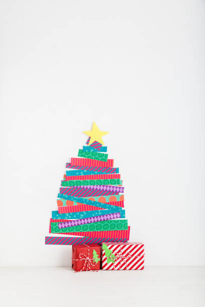 istock Paper cut Christmas tree and a presents. 1074688810