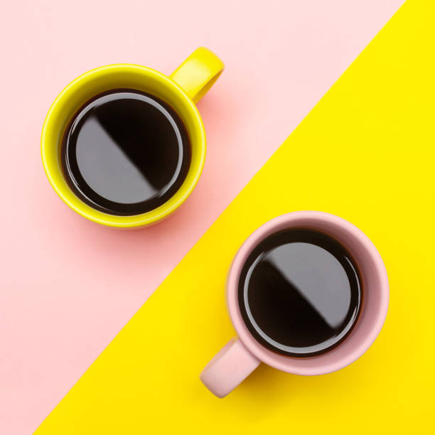 istock Flat lay of a two coffee cups with pink and yellow 1074691256