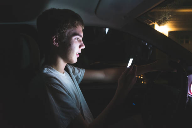 istock Teenager texting before he begins driving. 1074709944