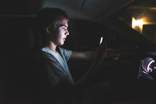 istock Teenager texting before he begins driving. 1074710172