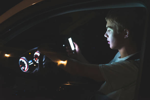 distracted teenage driver. - careless imagens e fotografias de stock
