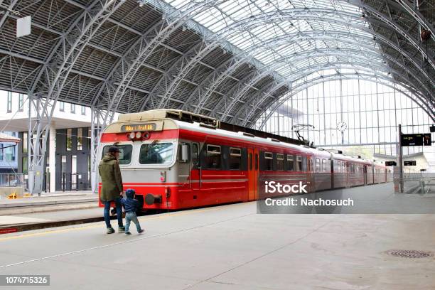 Young Mother And Little Kid Walk Through The Bergen Train Station Platforms With Typical Red Voss Train On Background Bergen Norway Stock Photo - Download Image Now