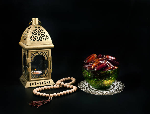 istock Ramadan lamp and prayer beads with dates in green bowl. 1074725746