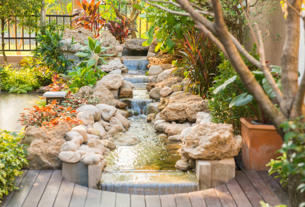 istock garden with a small steam and tree and stone 1074727936