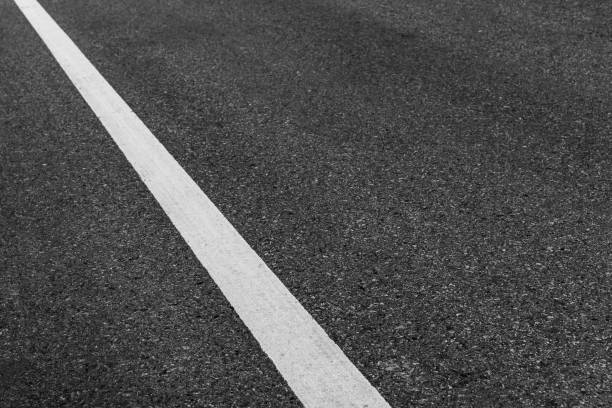 istock Asphalt road texture background, white guidelines on street. 1074732582