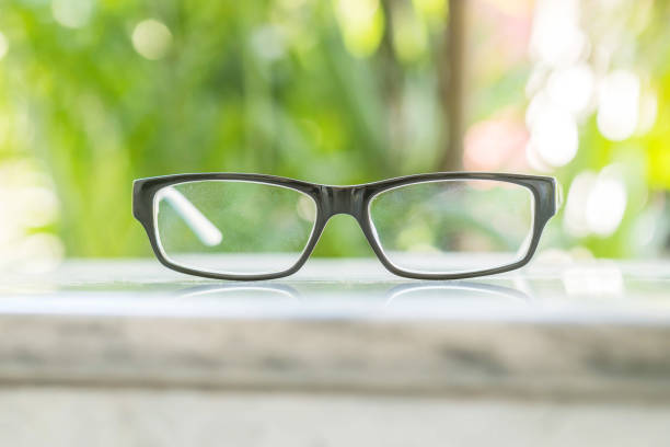 Glasses on table in the park with blurred tree background