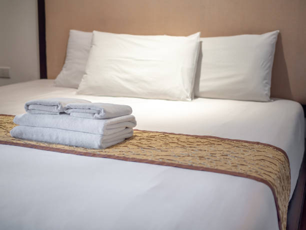 istock Clean towels on bed in hotel room 1074744412