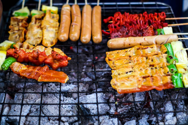 istock Beef, pork, beef, chicken and sausage are cooked on the stove 1074746320