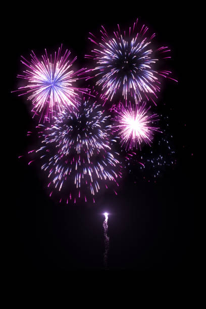 istock Beautiful purple fireworks with trail isolated on the black background 1074749304