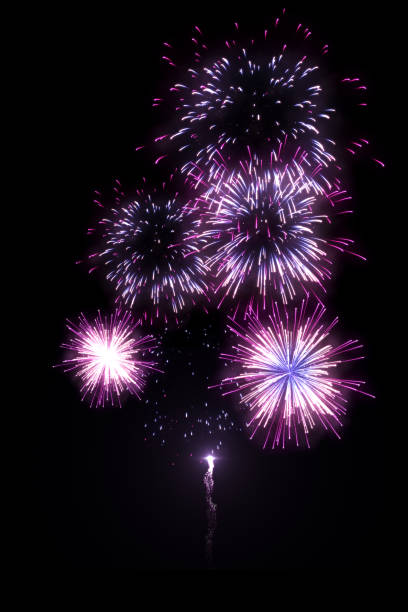 istock Beautiful purple fireworks with trail isolated on the black background 1074749378