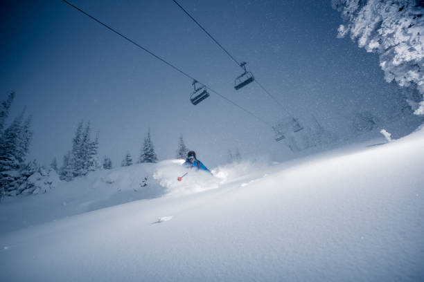 Storm skiing Storm skiing on powder day. ski resort flash stock pictures, royalty-free photos & images