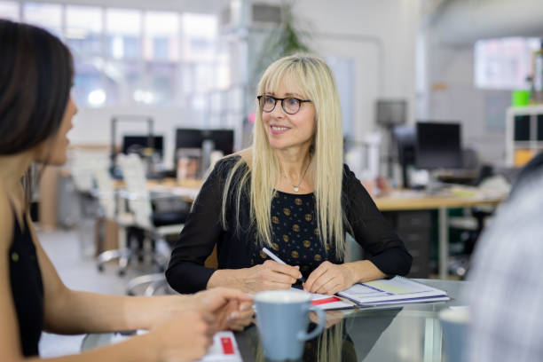 istock Small group of business professionals strategizing at a conference table 1074761164