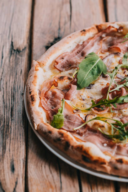istock Pizza carbonara on rustic wooden table 1074761600