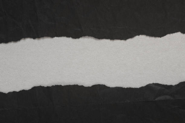 istock black torn paper with copy space on gray background 1074776878