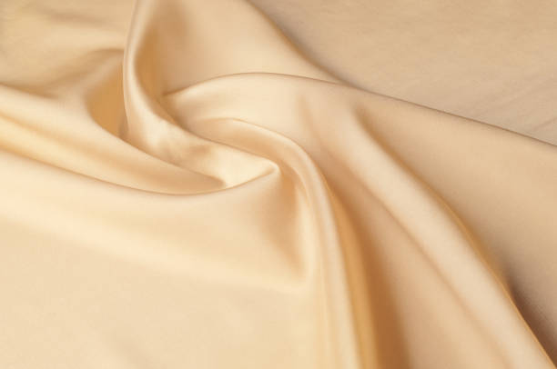 istock Texture background of fabric. Beige fabric. Silk fabric wallpaper texture background pattern in sepia pastel yellow cream beige tint: Lovely natural silk textured textile 1074781058