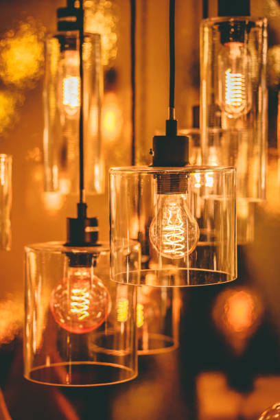 istock Close up view on a transparent modern lamp with a retro bulb inside it. 1074783298