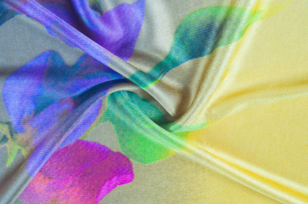 istock Background texture, pattern. silk fabric of yellow color with a floral pattern. Rinse down the memory strip with this nostalgic, multicolored floral pattern with digital printing. 1074784668