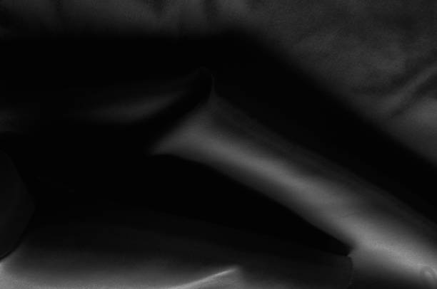 istock Soft focus cloth silk black. Take home this black washed silk! The washed black color is a soft, silky hand. Thin and light, it has a liquid drape that stands out when creating soft silhouettes. 1074784708