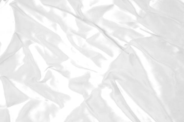 istock Texture, background, pattern. White silk fabric, Smooth elegant white silk or satin fabric fabric can be used as a wedding background. Luxury Christmas background or New Year background design 1074787198