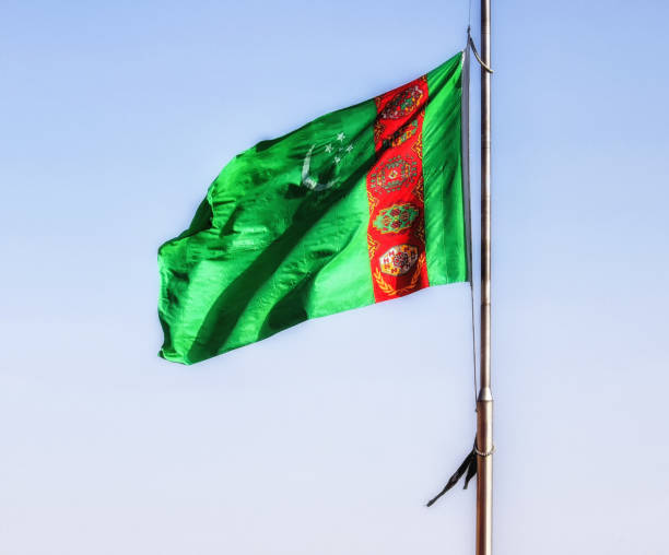 istock Turkmenistan flag waving in the blue sky 1074792862
