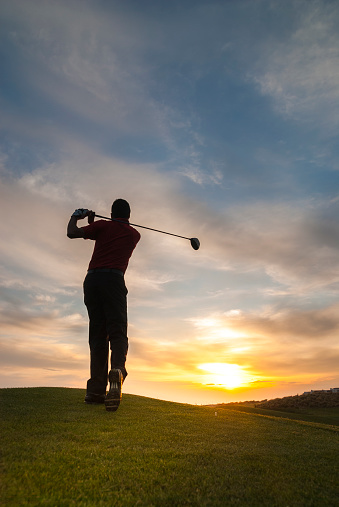 Golfer Silhouette with dramatic sky.