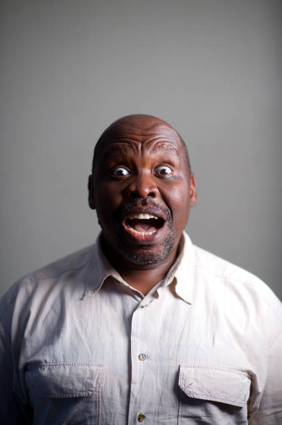 One senior male studio headshot shock eyes wide open Formal portrait with studio lighting Strand Cape Town South Africa