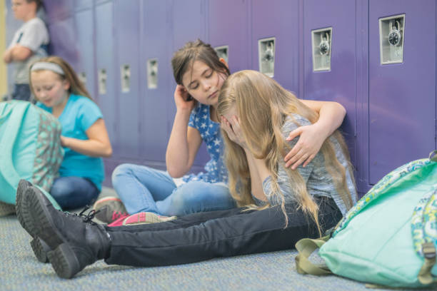 istock A friend consoling her friend at an elementary school 1074799796