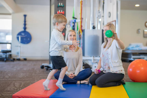 istock Young boy in a physiotherapy clinic 1074805190