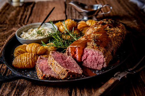 Freshly prepared whole beef fillet with potatoes and gravy