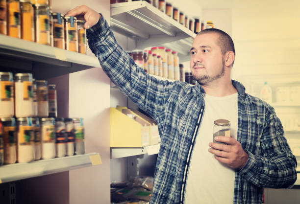 istock Cheerful male customer choosing pasta of nuts 1074805874