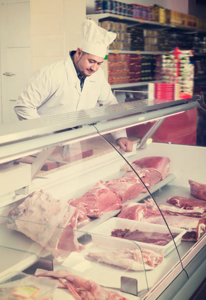 istock Cheerful man near display with cooled meat 1074805906