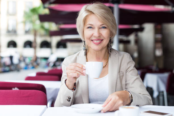 istock Mature businesswoman is drinking coffee 1074806116