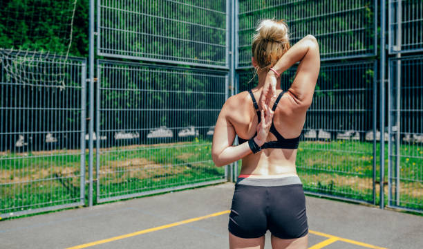 istock Sportswoman doing arm stretches 1074806802