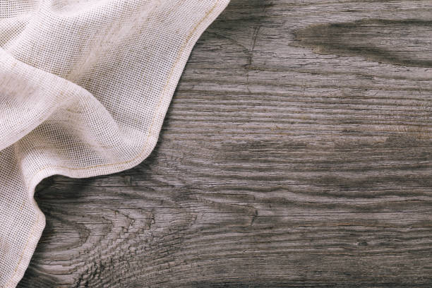 istock Top view of light tablecloth on left side of wooden table with copy space 1074806952