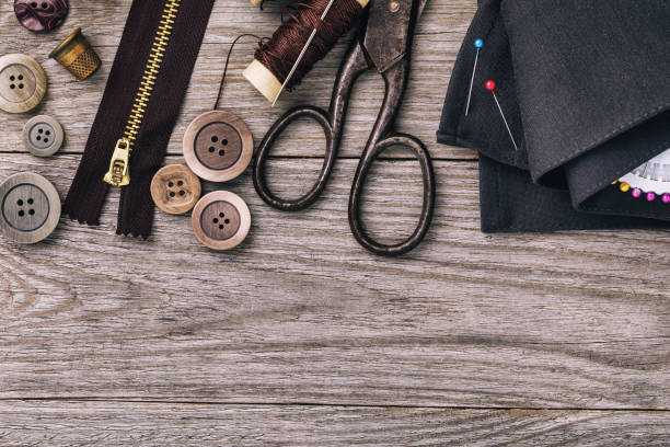 istock Tools for repairing clothes on wooden table with copy space, top view 1074808148