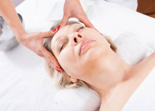 istock Mature woman having face massage 1074808504