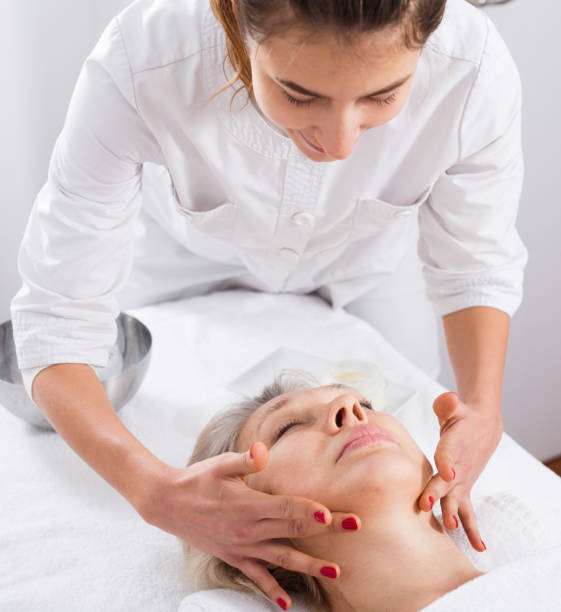 istock Mature woman having face massage 1074808506