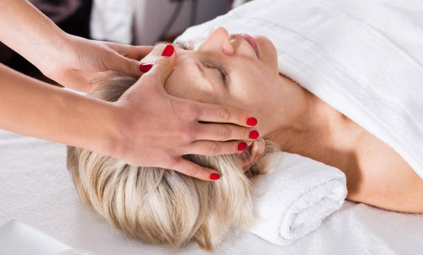 istock Mature woman having face massage 1074808512