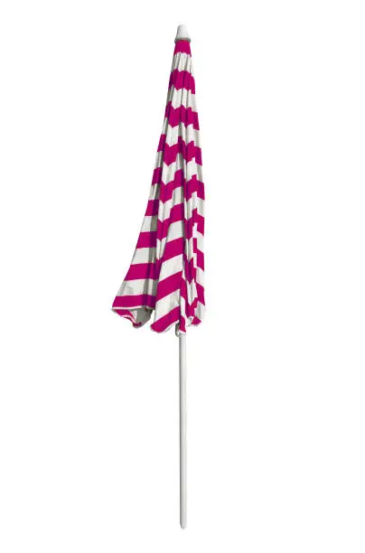 Closed pink striped beach umbrella isolated on white. Clipping path included.