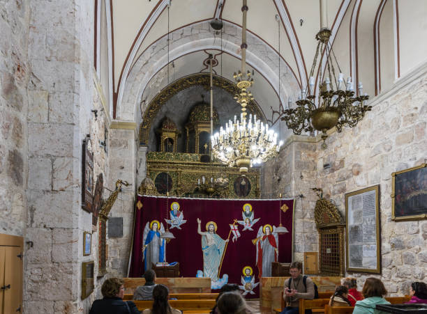 The guide tells visitors about St. Mark's Church - The Syrian Orthodox Church in old city of Jerusalem, Israel Jerusalem, Israel, November 24, 2018 : The guide tells visitors about St. Mark's Church - The Syrian Orthodox Church in old city of Jerusalem, Israel st markos church pic stock pictures, royalty-free photos & images