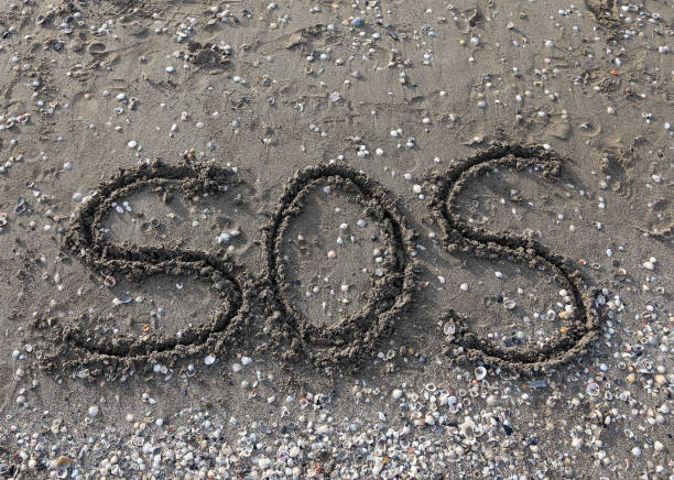 istock big text SOS on the sand 1074822786