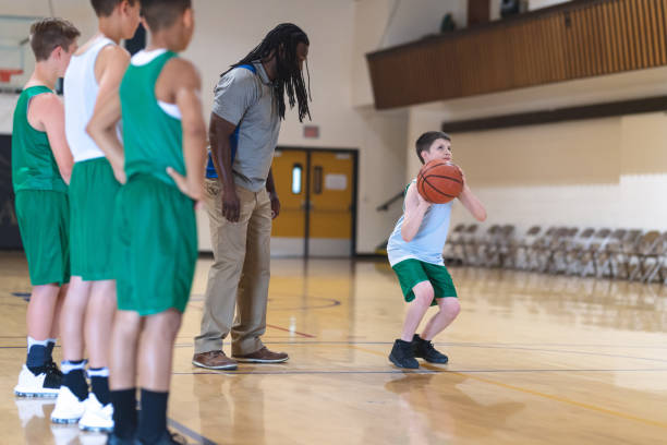 istock Coach talking with his elementary boy's basketball team 1074823264